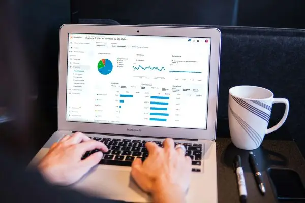 hand-typing-on-a-laptop-with-metrics-on-the-screen