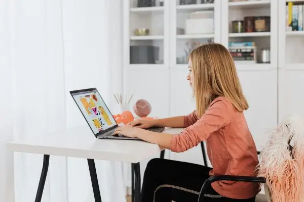 virtual-assistants-woman-in-orange-shirt-using-laptop