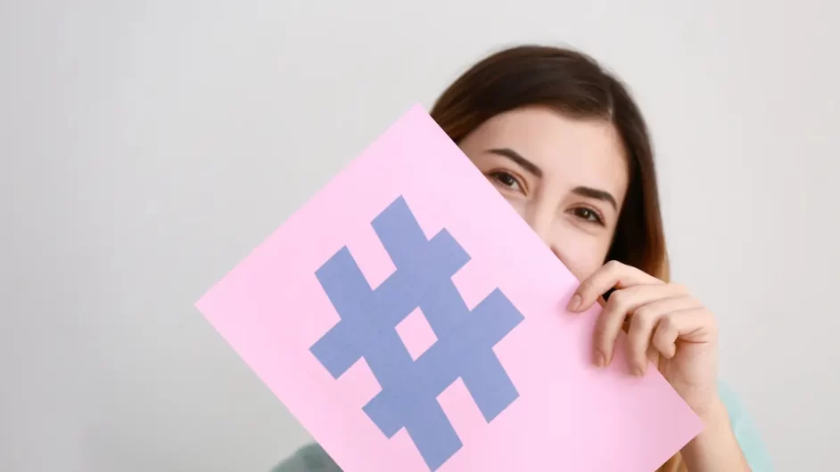 woman-holding-a-paper-with-hashtag